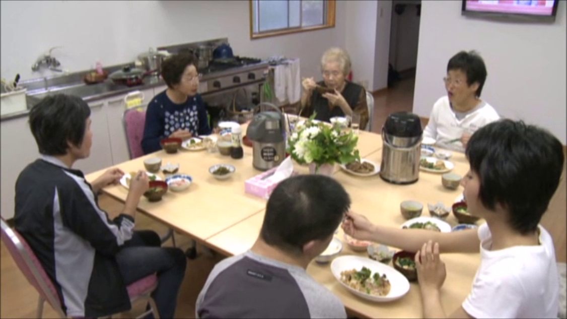 食卓を囲んで、みんなで一緒に昼食を食べている様子